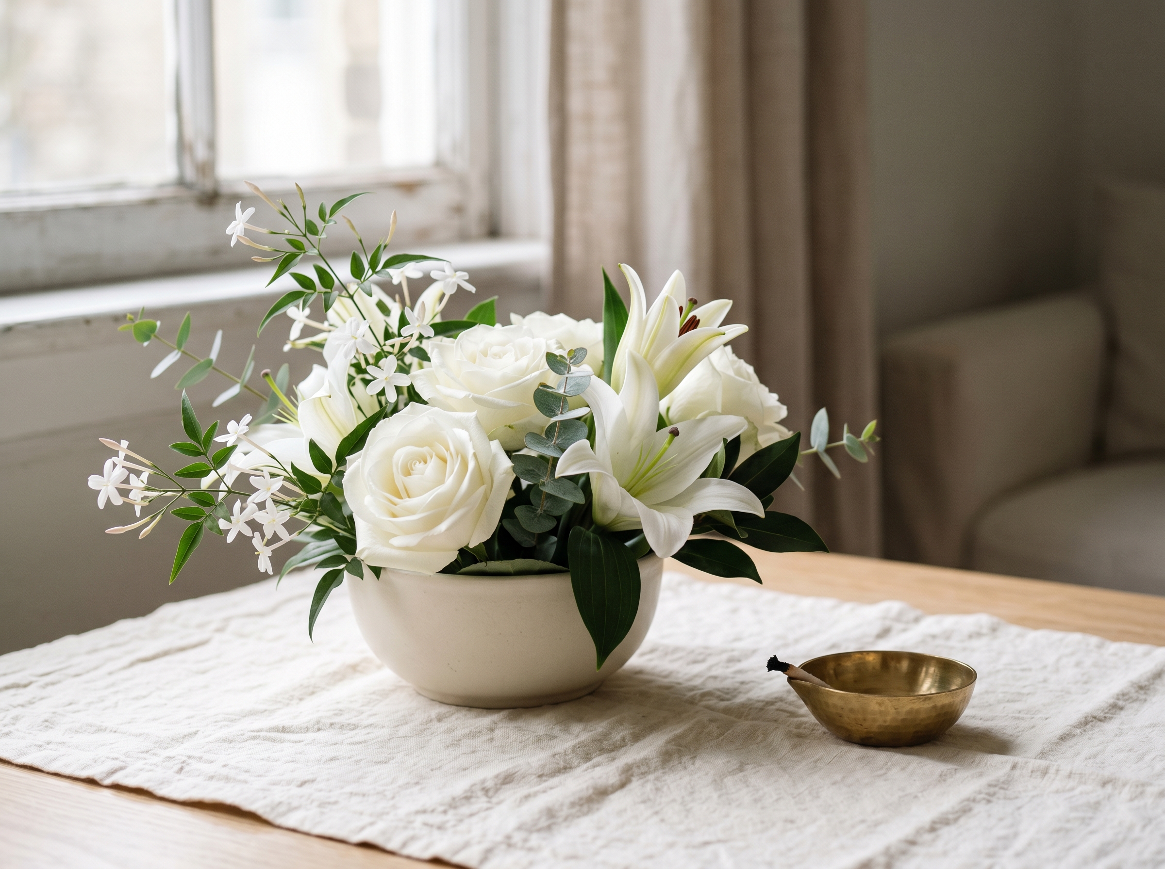 Quiet white-flower sympathy bouquet on cream cloth
